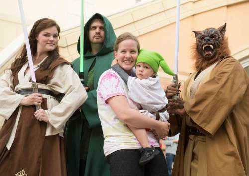 Rick Egan  |  The Salt Lake Tribune

Rebecca Pettit holds 3-year-old Rudy Pettitto as they pose with Star Wars characters to celebrate Star Wars Day with Salt Lake Comic Con and Urban Arts Gallery at The Gateway, Monday, May 4, 2015.