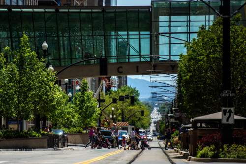 Chris Detrick  |  The Salt Lake Tribune
Pedestrians walk across Main Street by City Creek Center Wednesday April 29, 2015.
