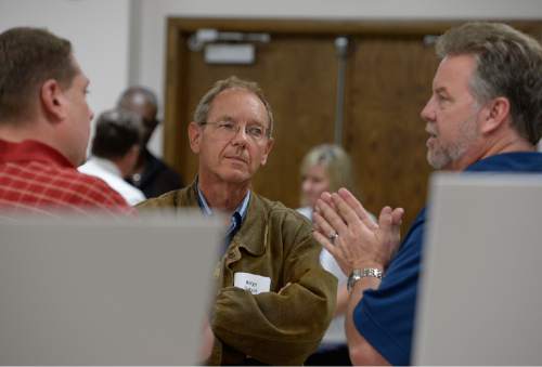 Scott Sommerdorf   |  The Salt Lake Tribune
Helge Gabert, center, of the Utah Department of Environmental Quality - speaks with Tooele resident Matt McCarty, left, and Chris Sloan of the Tooele County Chamber of Commerce, during the first of two public hearings the Department of Environmental Quality is planning to hold about EnergySolutions' plan to take up to 700,000 tons of depleted uranium over 30 years. The meeting was held at the Tooele County Courthouse, Wednesday, May 6, 2015
