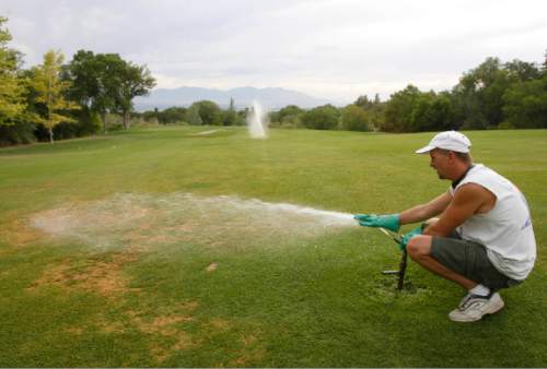 Rick Egan  |  Tribune file photo
Troy Kennedy sets the sprinklers at Bonneville golf course.