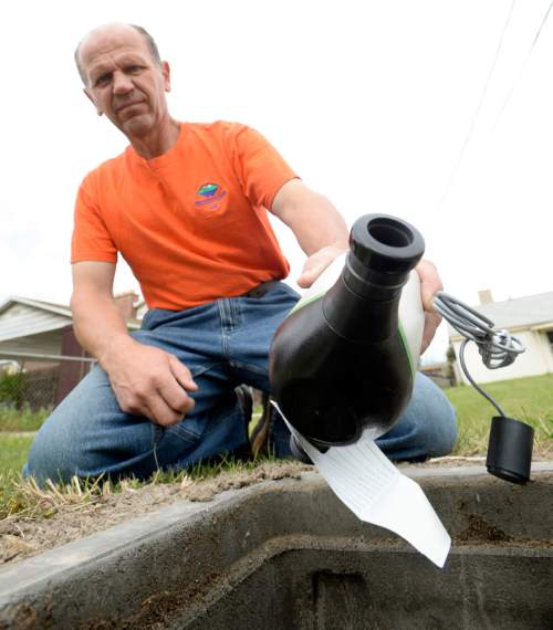 Al Hartmann  |  The Salt Lake Tribune
Val Cossey, meter maintenance technician with The Jordan Valley Water Conservancy District, installs a new water meter below ground at a home in South Salt Lake Tuesday May 5, 2015. Owners that request them will be provided instant information regarding their water use via a Web page. The idea behind the technology is that people will likely be more conservative with water if they can easily track it in a timely fashion. An audit released from the  Legislative Auditor General Tuesday says the state Division of Water and water conservancy districts need to do more to accurately track water use and promote conservation.