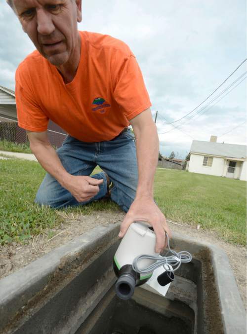Al Hartmann  |  The Salt Lake Tribune
Val Cossey, meter maintenance technician with The Jordan Valley Water Conservancy District, installs a new water meter below ground at a home in South Salt Lake Tuesday May 5, 2015. Owners that request them will be provided instant information regarding their water use via a Web page. The idea behind the technology is that people will likely be more conservative with water if they can easily track it in a timely fashion. An audit released from the  Legislative Auditor General Tuesday says the state Division of Water and water conservancy districts need to do more to accurately track water use and promote conservation.