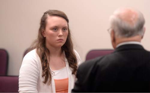 Al Hartmann |  The Salt Lake Tribune
Meagan Grunwald speaks to her defense lawyer Dean Zabriskie during a break in her trial. She took the witness stand in her own defense Wednesday May 6, 2015, in Judge Darold McDade's courtroom in Provo.  She is charged as an accomplice in a shooting spree that killed one police officer and wounded another on Jan. 30, 2014.