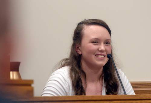 Al Hartmann |  The Salt Lake Tribune
Meagan Grunwald smiles as she recalls working on a truck transmission during testimony of her life experiences Wednesday May 6, 2015, in Judge Darold McDade's courtroom in Provo. She took the witness stand in her own defense for much of the day. She is charged as an accomplice in a shooting spree that killed one police officer and wounded another on Jan. 30, 2014.