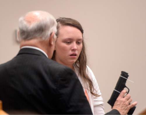Al Hartmann |  The Salt Lake Tribune
Defense attorney Dean Zabriskie questions his client Meagan Grunwald on the witness stand Wednesday May 6, 2015, in Judge Darold McDade's courtroom in Provo. He uses a disabled prop gun for demonstation purposes as to her proximity when Jose Angel Garcia-Jauregui pulled a gun on and shot Deputy Cory Wride. She testified in her own defense. She is charged as an accomplice in a shooting spree that killed one police officer and wounded another on Jan. 30, 2014.