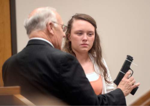 Al Hartmann |  The Salt Lake Tribune
Defense attorney Dean Zabriskie questions his client Meagan Grunwald on the witness stand Wednesday May 6, 2015, in Judge Darold McDade's courtroom in Provo. He uses a disabled prop gun for demonstation purposes as to her proximity when Jose Angel Garcia-Jauregui pulled a gun and shot Deputy Cory Wride. She testified in her own defense. She is charged as an accomplice in a shooting spree that killed one police officer and wounded another on Jan. 30, 2014.