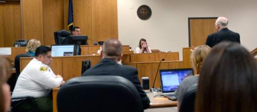 Al Hartmann |  The Salt Lake Tribune
Defense lawyer Dean Zabriskie, right, questions Meagan Grunwald, center, as she takes the witness stand in her own defense Wednesday May 6, 2015, in Judge Darold McDade's courtroom in Provo. She is charged as an accomplice in a shooting spree that killed one police officer and wounded another on Jan. 30, 2014.