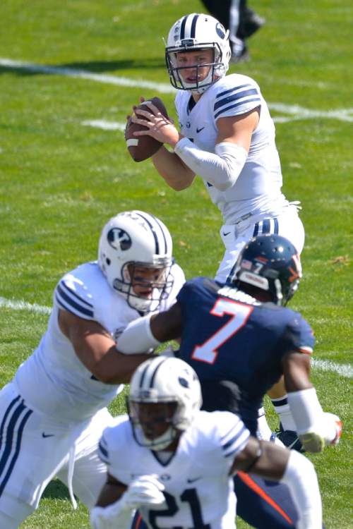 Chris Detrick  |  Tribune file photo
Brigham Young Cougars quarterback Taysom Hill (4) looks to pass the ball during the game at LaVell Edwards Stadium Saturday September 20, 2014.  Virginia is winning the game 16-13 at halftime.