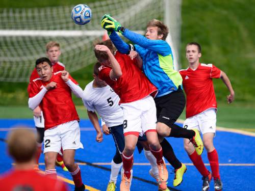 Scott Sommerdorf   |  The Salt Lake Tribune
Manti goalkeeper Tristan Daniels leaps to punch away a first half shot on goal, bumping into his team mate Jake Neilsen. American Leadership Academy (ALA) defeated Manti 4-0 in a 3A semi-final played at Juan Diego High, Friday, May 8, 2015.
