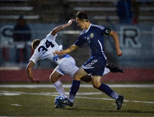 Scott Sommerdorf   |  The Salt Lake Tribune
Pineview's Ben Sears falls as he battles with Snow Canyon's Chase Overfelt during a driving rainstorm as Pineview defeated Snow Canyon 2-1 in a 2A semi-final game at Alta High, Friday, May 8, 2015.