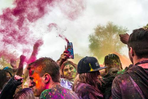 Chris Detrick  |  The Salt Lake Tribune
Revelers dance and throw colored powder during the 4th Annual Festival of Colors at the Krishna Temple in Salt Lake City Saturday May 9, 2015.