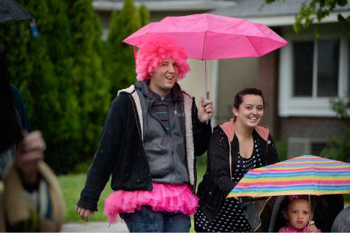 Scott Sommerdorf   |  The Salt Lake Tribune
The 19th Annual Susan G. Komen Race for the Cure heads for Library Square during a steady rainstorm, Saturday, May 9, 2015.