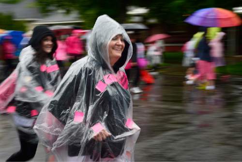 Scott Sommerdorf   |  The Salt Lake Tribune
The 19th Annual Susan G. Komen Race for the Cure heads for Library Square during a steady rainstorm, Saturday, May 9, 2015.