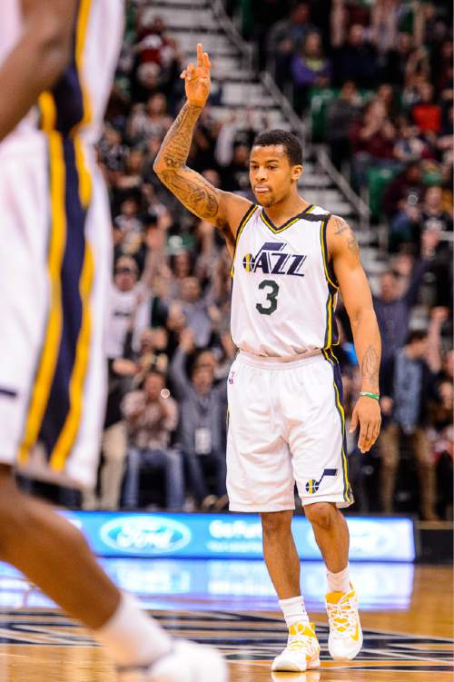 Trent Nelson  |  The Salt Lake Tribune
Utah Jazz guard Trey Burke (3) signals to the crowd after sinking a cross-court shot at the end of the first quarter, as the Utah Jazz host the Sacramento Kings at EnergySolutions Arena in Salt Lake City, Wednesday April 8, 2015.