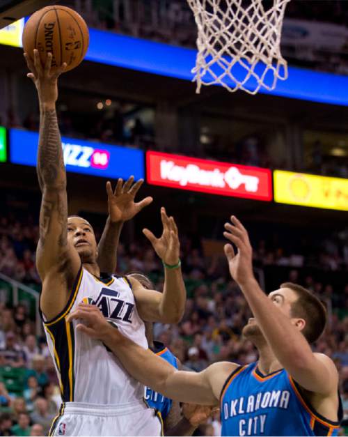 Lennie Mahler  |  The Salt Lake Tribune

Trey Burke scores a layup over Mitch McGary in the first half of a game between the Utah Jazz and Oklahoma City Thunder at EnergySolutions Arena on Saturday, March 28, 2015.