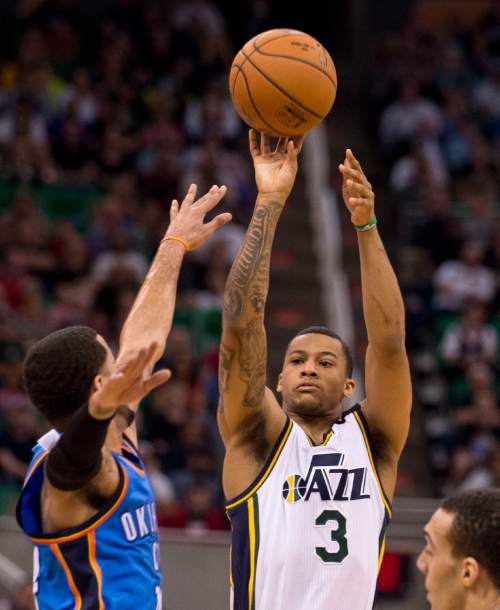 Lennie Mahler  |  The Salt Lake Tribune

Trey Burke shoots over D.J. Augustin in the first half of a game between the Utah Jazz and Oklahoma City Thunder at EnergySolutions Arena on Saturday, March 28, 2015.