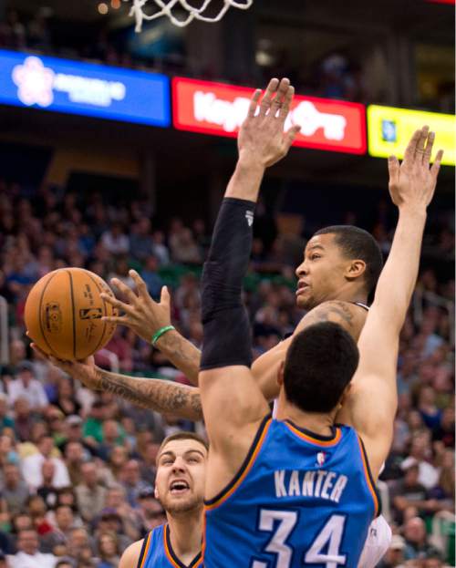 Lennie Mahler  |  The Salt Lake Tribune

Trey Burke draws a foul on Enes Kanter in the first half of a game between the Utah Jazz and Oklahoma City Thunder at EnergySolutions Arena on Saturday, March 28, 2015.