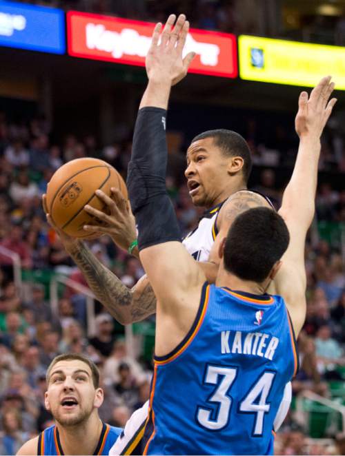 Lennie Mahler  |  The Salt Lake Tribune

Trey Burke draws a foul on Enes Kanter in the first half of a game between the Utah Jazz and Oklahoma City Thunder at EnergySolutions Arena on Saturday, March 28, 2015.