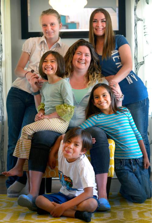 Leah Hogsten  |  The Salt Lake Tribune
Clockwise from bottom; Jude, 7, Rowan, 6, Savannah, 15, Shelby, 17, True, 8, and their mother Chrissy Watson, who adopted them while in her and her husband's foster care.  Watson and her husband Eli (not shown),  have fostered more than 100 children in 8 years and they emphasize the need for foster homes for teenagers and young people, who age out of foster care.