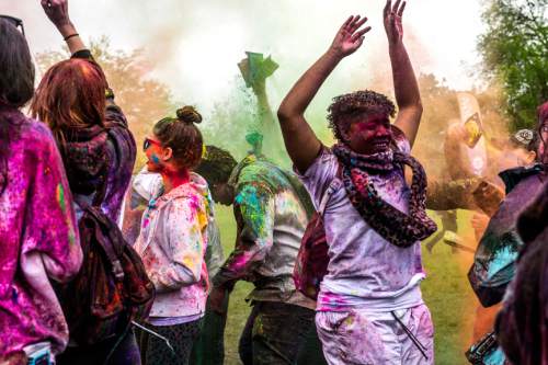 Chris Detrick  |  The Salt Lake Tribune
Revelers dance and throw colored powder during the 4th Annual Festival of Colors at the Krishna Temple in Salt Lake City Saturday May 9, 2015.