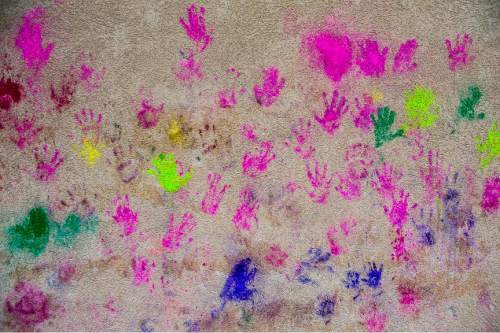 Chris Detrick  |  The Salt Lake Tribune
Hand prints on a wall from revelers during the 4th Annual Festival of Colors at the Krishna Temple in Salt Lake City Saturday May 9, 2015.