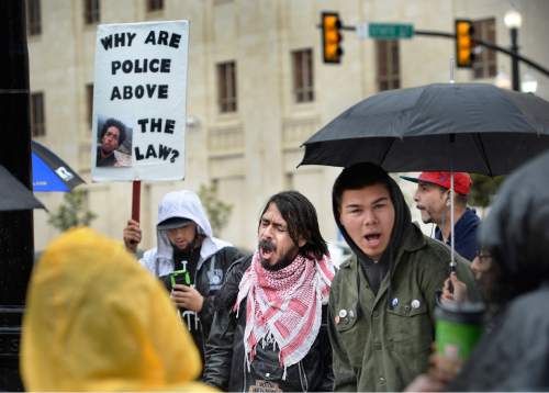 Scott Sommerdorf   |  The Salt Lake Tribune
Supporters of Utah Against Police Brutality shout slogans at the corner of 100 South and State Street during the Utah Against Police Brutality rally on  Saturday.