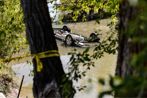 Trent Nelson  |  The Salt Lake Tribune
A car found overturned in the Jordan River south of the Fairgrounds, Sunday May 10, 2015.