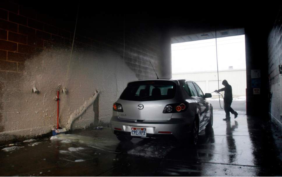 Rick Egan  | The Salt Lake Tribune 

Marvin Gonzalez washes a car at a car wash on North Temple, Monday, January 7, 2013. Rep. Eric Hutchings claims a car wash scammed him, and may be scamming others -- which he hopes to stop with legislation