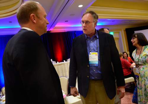 Scott Sommerdorf   |  The Salt Lake Tribune
John Robinson, right, speaks with fellow speaker Thorkil Sonne after Sonne spoke at the International Society for Autism Research conference held at Little America Hotel, Wednesday, May 13, 2015.