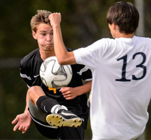 Trent Nelson  |  The Salt Lake Tribune
Wasatch's Griffin Hall (4) kicks the ball, ahead of Skyline's Sheldon Martineau (13) in a first round Class 4A soccer state game between Wasatch and Skyline High School, in Salt Lake City, Wednesday May 13, 2015.