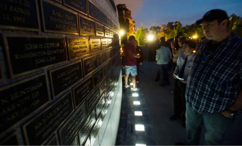 Steve Griffin  |  The Salt Lake Tribune
Lights illuminate the brass plaques containing the names of fallen officers during a candlelight vigil hosted by the Utah Fraternal Order of Police, along with the Utah Fraternal Order of Police Auxiliary, to show appreciation to police officers who died in the line of duty at the The Utah Law Enforcement Memorial on the Utah State Capitol grounds in Salt Lake City on Wednesday.