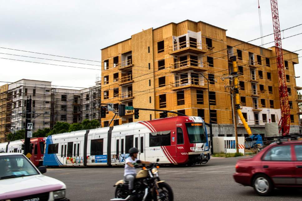 Chris Detrick  |  Tribune file photo
TRAX train zips past apartment construction along 400 South and 500 East. A new study says one of the big benefits of mass transit is development and jobs.