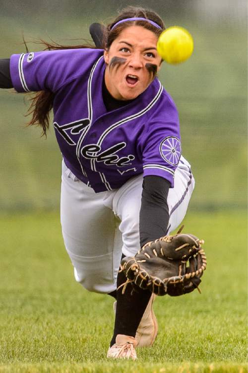 Trent Nelson  |  The Salt Lake Tribune
Lehi's Taylor Tahbo dives for a ball during a 5A softball tournament second-round game between defending champion Lehi and No. 1 seed Taylorsville, Thursday May 14, 2015.