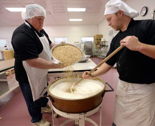 Al Hartmann |  The Salt Lake Tribune
Mike Wall, President of Mrs. Cavanaugh's Chocolates, left, and Trevor Wall mix up ingredients for a 100 lb. batch of White Chocolate Coconut Almond bars at the factory in North Salt Lake.  According to sales statistics from Hershey's Co., Utahns purchase more confections ó candy, mints and gum, than any region in the nation.