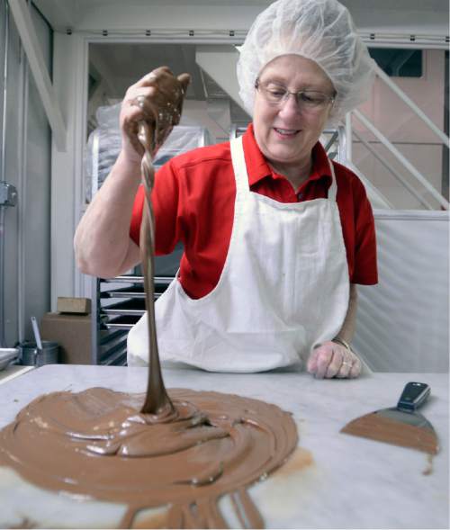 Al Hartmann |  The Salt Lake Tribune
Brenda Roundy works warm chocolate to perfect consistency to make hand-dipped almond clusters at  Mrs. Cavanaugh's Chocolates at the factory in North Salt Lake.  According to sales statistics from Hershey's Co., Utahns purchase more confections -- candy, mints and gum, than any region in the nation.