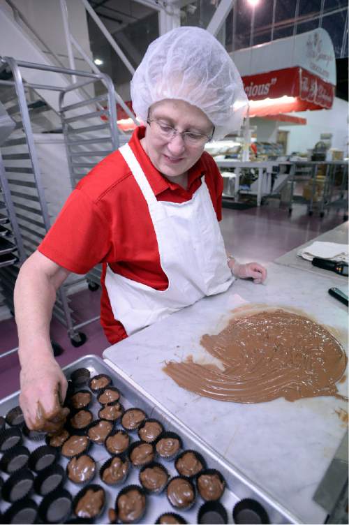Al Hartmann |  The Salt Lake Tribune
Brenda Roundy makes hand-dipped almond clusters at Mrs. Cavanaugh's Chocolates at the factory in North Salt Lake.  According to sales statistics from Hershey's Co., Utahns purchase more confections ó candy, mints and gum, than any region in the nation.