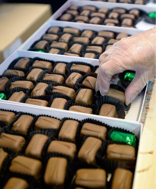 Al Hartmann |  The Salt Lake Tribune
Laurie Brenneise hand packs Mindy MInt Truffle gift boxes at  Mrs. Cavanaugh's Chocolate factory in North Salt Lake.  According to sales statistics from Hershey's Co., Utahns purchase more confections ó candy, mints and gum, than any region in the nation.