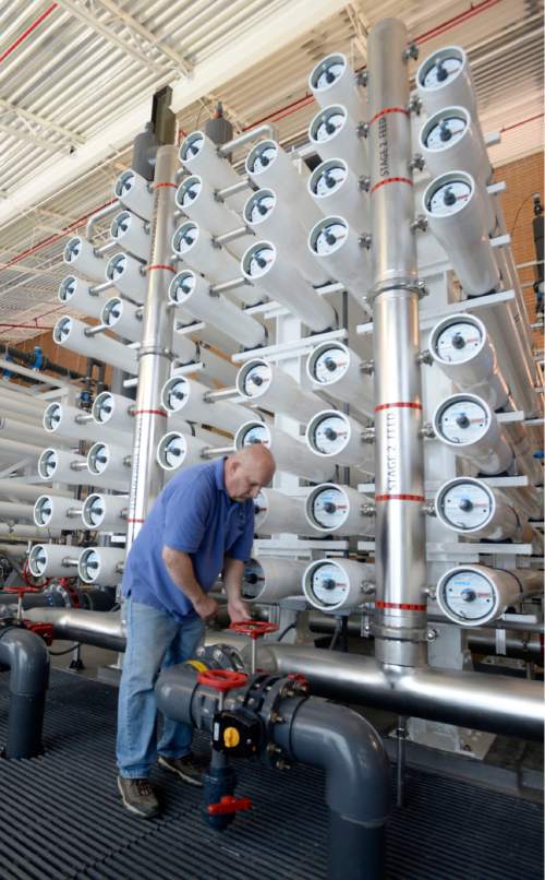 Al Hartmann |  The Salt Lake Tribune
Lead operator Mike Axelgard works on Jordan Valley Water Conservancy District's reverse osmosis Southwest Groundwater Treatment Plant Wednesday May 13, 2015. It's reaching its final phase to clean up a plume contaminated by historic mining activities at Bingham Canyon. The Southwest Groundwater Treatment Plant uses reverse osmosis to produce 4,500 acre feet of clean drinking water a year. Now the district is seeking final permission to pipe 1.5 million gallons of selenium-laced byproduct water in the Great Salt Lake.