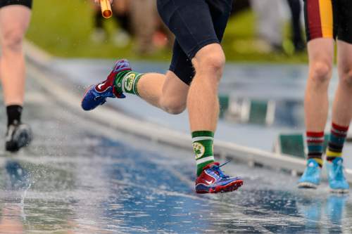 Trent Nelson  |  The Salt Lake Tribune
Runners race as the rain pours down at the state high school track meet in Provo, Saturday May 16, 2015.