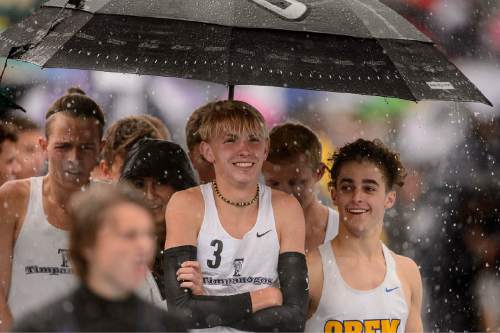 Trent Nelson  |  The Salt Lake Tribune
Runners wait out a downpour at the state high school track meet in Provo, Saturday May 16, 2015.