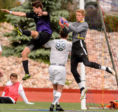 Trent Nelson  |  The Salt Lake Tribune
Alta's Alex Johnson knocks the ball down during the 5A boys' soccer semifinal with Alta vs. Lehi High School, in Woods Cross, Tuesday May 19, 2015.