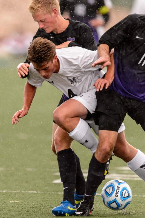 Trent Nelson  |  The Salt Lake Tribune
Alta's Mitch Fisher slides between two Lehi defenders during the 5A boys' soccer semifinal with Alta vs. Lehi High School, in Woods Cross, Tuesday May 19, 2015.