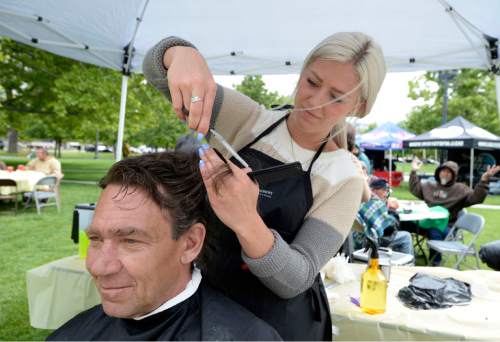 Al Hartmann |  The Salt Lake Tribune
Bobby Dyches gets a free haircut from hair stylist Anna Ence at the  Sixth Annual Subway Day in Pioneer Park Tuesday May 19, 2015. Subway Restaurants of Utah teamed up with the Rescue Mission of Salt Lake for "Subway Day" for the past six years. This event not only provides food, but will give the homeless and low income new shoes, and clothing along with other needed items.