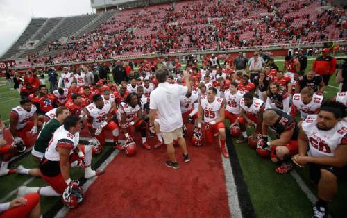 Utah coach Kyle Whittingham speaks with his players at the NCAA college football team's spring game Saturday, April 25, 2015, in Salt Lake City. (AP Photo/Rick Bowmer)