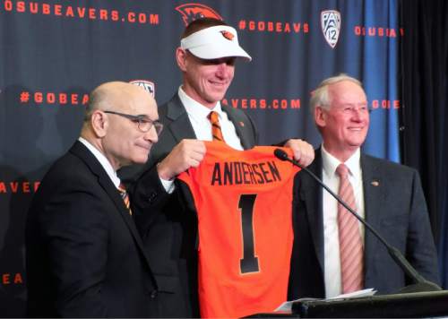 FILE-  In this Dec. 12, 2014, file photo, Oregon State new football coach, Gary Andersen, center, poses with Oregon State athletic director, Bob De Carolis, left, and Oregon State University president, Edward Ray, at a news conference in Corvallis, Ore. De Carolis released an open letter Monday, May 11, 2015, announcing his decision to step down on June 30.  (AP Photo/Anne Peteson, File)