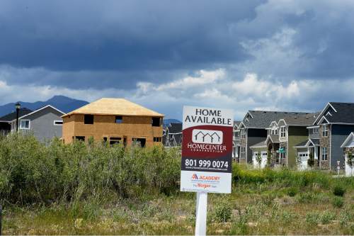 Scott Sommerdorf   |  The Salt Lake Tribune
Housing development is underway near South Kelso Dune Drive, and within sight of the Oquirrh Temple in South Jordan, Wednesday, May 20, 2015.  South Jordan has beat out Taylorsville as Utah's 10th most populous city, after Taylorsville held the 10th spot for the prior four years.