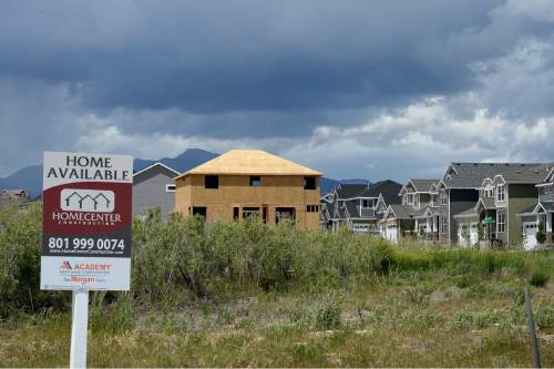 Scott Sommerdorf   |  The Salt Lake Tribune
Housing development is underway near South Kelso Dune Drive, and within sight of the Oquirrh Temple in South Jordan, Wednesday, May 20, 2015.  South Jordan has beat out Taylorsville as Utah's 10th most populous city, after Taylorsville held the 10th spot for the prior four years.