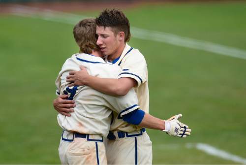Scott Sommerdorf   |  The Salt Lake Tribune
Easton Walker, left, hugs starting pitcher Logan Carlson after Pleasant Grove defeated Cottonwood 3-2 to win the winner's bracket final at UVU, Thursday, May 21, 2015. Christiansen doubled in the winning run to win the game.