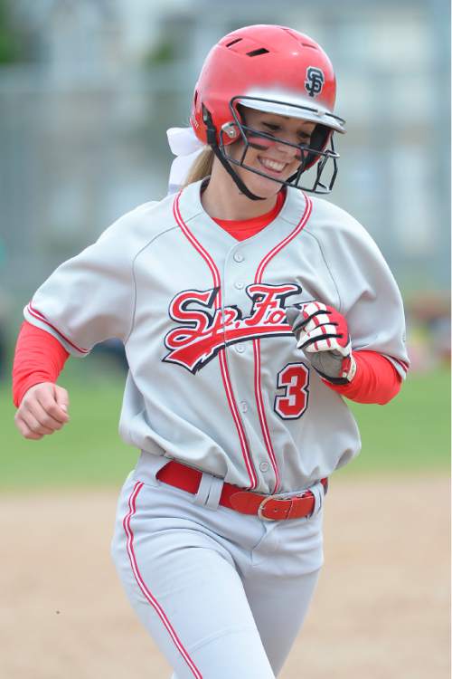 Leah Hogsten  |  The Salt Lake Tribune
Spanish Fork's Kenzie Branch reacts to hitting a home run in the 6th inning bringing runner Whitney Perkins. Spanish Fork High School girls softball team defeated Springville High School 7-1 during their 4A state semifinal game Thursday, May 21, 2015 at the Taylorsville Valley Softball Complex.