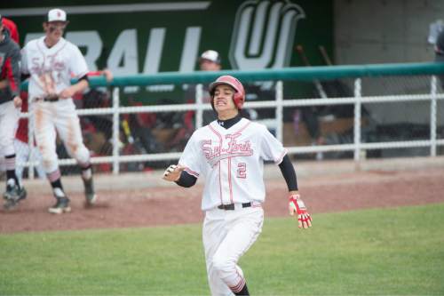 Rick Egan  |  The Salt Lake Tribune

Spanish Fork Dons Nic Roberts (2) scores  the go-ahead run in the 6th inning, on a double by Devin Argyle (15), in prep 4A baseball playoff action, Spanish Fork vs Maple Mountain, at Brent Brown field in Orem, Friday, May 22, 2015.